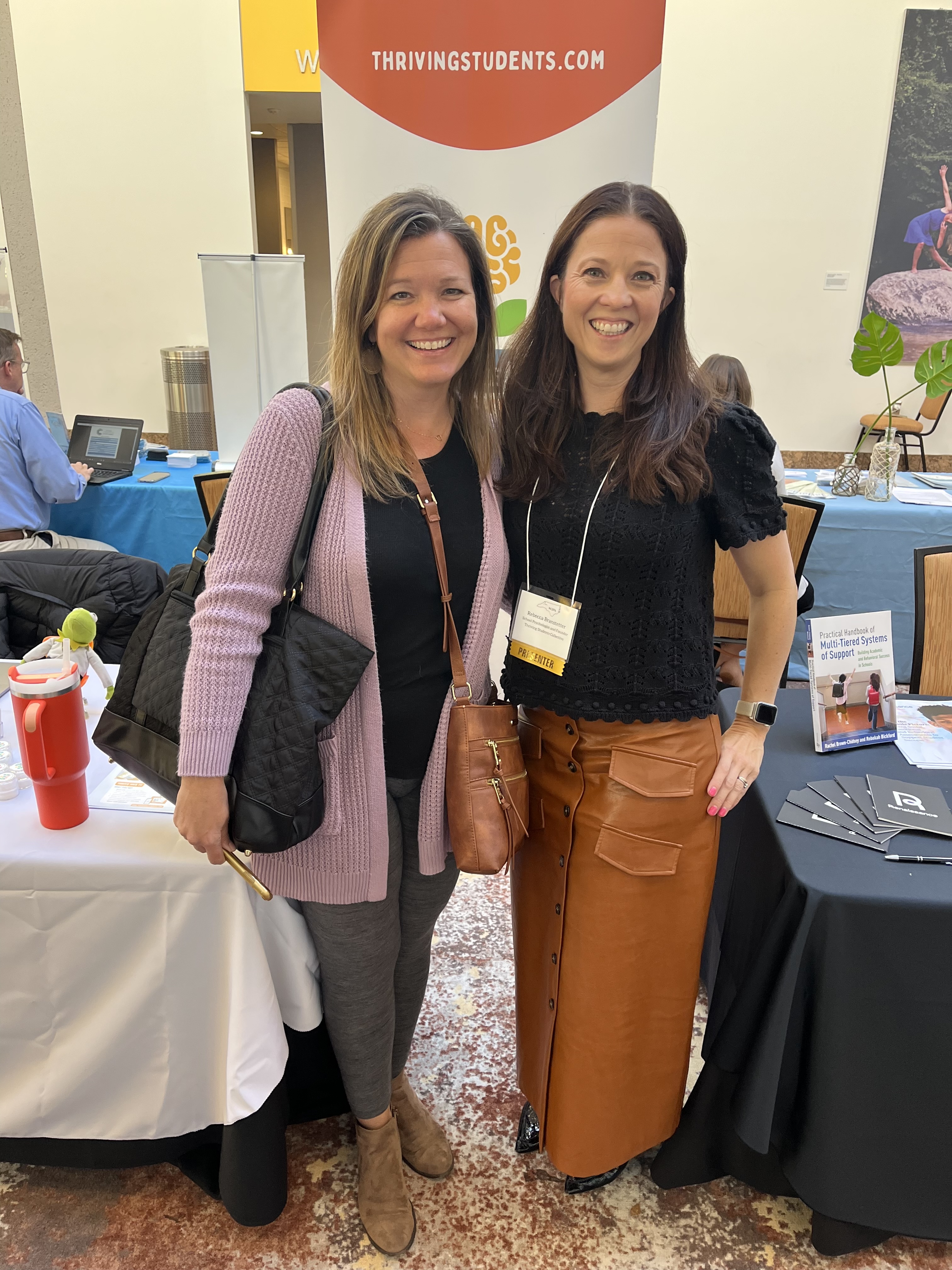 Two people near exhibitor booths